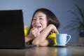 Young pretty and happy Asian Korean woman at desk enjoying internet on laptop computer smiling cheerful having fun drinking tea cu Royalty Free Stock Photo