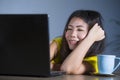 Young pretty and happy Asian Korean woman at desk enjoying internet on laptop computer smiling cheerful having fun drinking tea cu Royalty Free Stock Photo