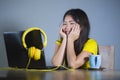 Young pretty and happy Asian Korean woman at desk enjoying internet on laptop computer smiling cheerful having fun drinking tea cu Royalty Free Stock Photo