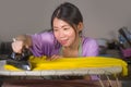 Young pretty and happy Asian Korean woman using iron at home kitchen ironing clothes smiling cheerful and carefree enjoying domest Royalty Free Stock Photo