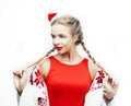 Young pretty happy smiling blond woman on christmas in santas red hat and decorated blanket isolated on white background Royalty Free Stock Photo