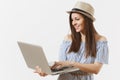 Young pretty happy woman in blue dress, hat working on modern laptop pc computer isolated on white background. People Royalty Free Stock Photo