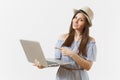 Young pretty happy woman in blue dress, hat working on modern laptop pc computer isolated on white background. People Royalty Free Stock Photo