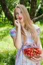 Young pretty happy woman eating strawberry Royalty Free Stock Photo