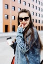 Young pretty hipster girl student with coffee cup posing adorable smiling, lifestyle people concept outdoor Royalty Free Stock Photo