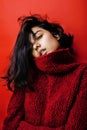 Young pretty indian mulatto girl in red sweater posing emotional, fashion hipster teenage, lifestyle people concept Royalty Free Stock Photo