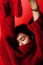 Young pretty indian mulatto girl in red sweater posing emotional, fashion hipster teenage, lifestyle people concept