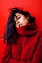 Young pretty indian mulatto girl in red sweater posing emotional, fashion hipster teenage, lifestyle people concept Royalty Free Stock Photo