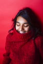 Young pretty indian mulatto girl in red sweater posing emotional Royalty Free Stock Photo