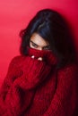 Young pretty indian mulatto girl in red sweater posing emotional Royalty Free Stock Photo