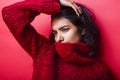 Young pretty indian mulatto girl in red sweater posing emotional Royalty Free Stock Photo