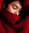 Young pretty indian mulatto girl in red sweater posing emotional, fashion hipster teenage, lifestyle people concept Royalty Free Stock Photo