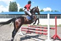 Young pretty jockey girl preparing horse for ride. love horses. girl riding a horse