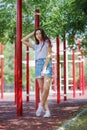 A young pretty lady in casual clothes on a blurred natural background. Fashion, urban, youth concept. Copy space.