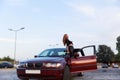 Young pretty lady with a clasic car Royalty Free Stock Photo