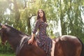 Young pretty latin girl laying on horseback in the forest. love animals concept. love horses Royalty Free Stock Photo