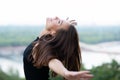 Young pretty likable cheerful woman posing summer city outdoor in Kyiv, Ukraine. Beautiful self-confident girl dressed in black