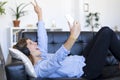 Young pretty long hair woman lying on a sofa making selfie on he Royalty Free Stock Photo