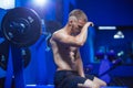 Young pretty man tired after weightlifting at gym Royalty Free Stock Photo