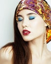 young pretty modern girl with bright shawl on head emotional pos