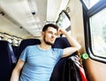 Young pretty modern hipster guy traveller on train with skateboard alone, lifestyle vacation people concept close up Royalty Free Stock Photo