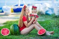 Young pretty mother playing with her little cute daughter at the beach. Loving mom having fun with her child at the sea shore with Royalty Free Stock Photo