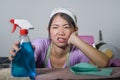 Young pretty overworked and frustrated Asian Chinese service maid woman working domestic cleaning and washing home kitchen stresse Royalty Free Stock Photo