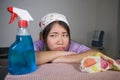 Young pretty overworked and frustrated Asian Chinese service maid woman working domestic cleaning and washing home kitchen stresse Royalty Free Stock Photo