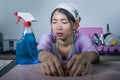 Young pretty overworked and frustrated Asian young pretty overworked and frustrated Asian Chinese service maid woman working domes Royalty Free Stock Photo