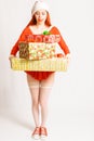 Young and pretty red head girl in a Santa Claus mini dress on a neutral white backgroung