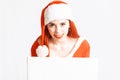 Young and pretty red head girl in a Santa Claus mini dress on a neutral white backgroung