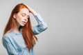 Young pretty redhead girl with freckles looking at camera smiling touching hair Royalty Free Stock Photo