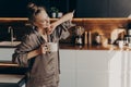 Young pretty relaxed woman in pajama with cup of coffee in morning