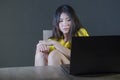 Young pretty shocked and surprised Asian Korean woman looking stressed at laptop computer feeling amazed and scared in cyber bully Royalty Free Stock Photo