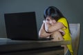 Young pretty shocked and surprised Asian Korean woman looking stressed at laptop computer feeling amazed and scared in cyber bully Royalty Free Stock Photo