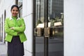 Young scort woman or crew smiling crossed arms green