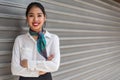 Young scort woman or crew smiling crossed arms green