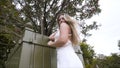 Young pretty sexy caucasian woman in white dress in a blooming spring garden. Action. Youth, freshness, beauty, romance Royalty Free Stock Photo