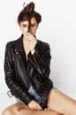 Young pretty woman in leather jacket, lifestyle hipster girl posing isolated on white background Royalty Free Stock Photo