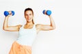 Young pretty slim blond woman with dumbbell isolated cheerful sm Royalty Free Stock Photo