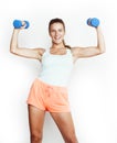 young pretty slim blond woman with dumbbell isolated cheerful smiling, measuring herself, diet people concept on white Royalty Free Stock Photo