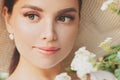 Young pretty smiling woman with flowers, perfect female face close up portrait Royalty Free Stock Photo