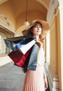 Young pretty smiling woman in hat with bags on shopping at store gallery, lifestyle people concept Royalty Free Stock Photo