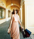 Young pretty smiling woman in hat with bags on shopping at store Royalty Free Stock Photo