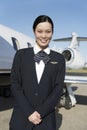 Young Pretty Stewardess Standing At Airfield