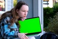 young pretty student woman bored tired over worked on her laptop wearing a black shirt isolated on green screen cromakey Royalty Free Stock Photo