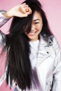 Young pretty stylish hipster asian girl posing emotional isolated on pink background happy smiling cool smile, lifestyle Royalty Free Stock Photo