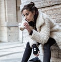 Young pretty stylish teenage girl outside on city street fancy fashion dressed drinking milk shake Royalty Free Stock Photo