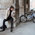 Young pretty stylish teenage girl outside on city street fancy fashion dressed drinking milk shake Royalty Free Stock Photo