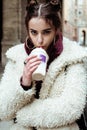 Young pretty stylish teenage girl outside on city street fancy fashion dressed drinking milk shake Royalty Free Stock Photo